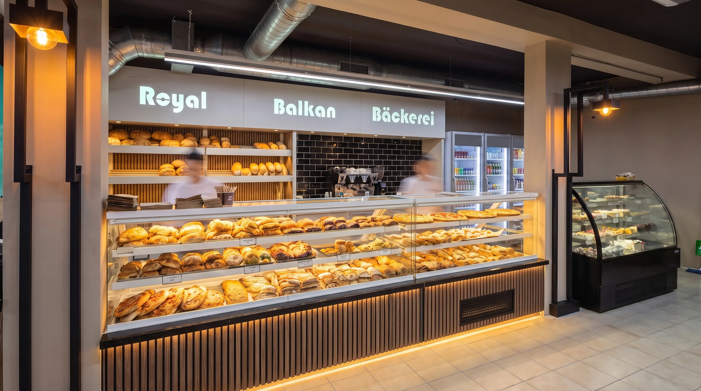 Die lange Theke voller Gebäck unter dem beleuchteten Schriftzug Royal Balkan Bäckerei